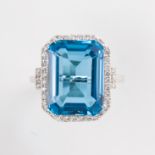 A blue topaz, diamond and fourteen karat gold ring