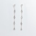 A pair of diamond and fourteen karat white gold earrings