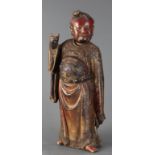 A Chinese red lacquered wood figure of an Official