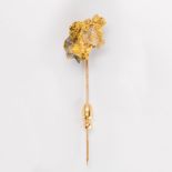 A gold specimen and fourteen karat gold stick pin