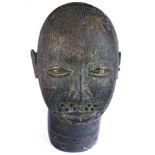 A West African style decorative sculpture of a stylized face