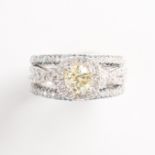 A fancy light yellow diamond and ten karat white gold ring