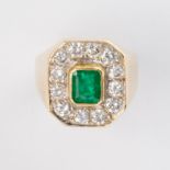 An emerald, diamond and eighteen karat gold ring