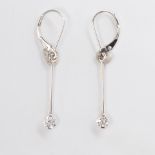 A pair of diamond and fourteen karat white gold earrings