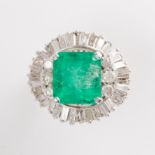 An emerald, diamond and fourteen karat gold ring