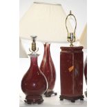 Three Chinese oxblood glaze vases mounted as lamps, the largest 26"h