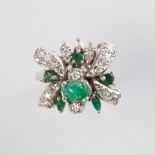 An emerald and fourteen karat white gold ring
