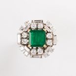 An emerald, diamond and fourteen karat gold ring