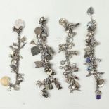 A group of silver charm bracelets
