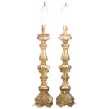 A pair of Rococo style giltwood candle prickets