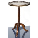 A Victorian style walnut veneered tea table with a brass galleried top