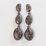 A pair of colored diamond patinated earrings