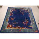 A Chinese Art Deco carpet, the cobalt blue ground decorated with flowers and vases