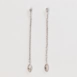 A pair of diamond and fourteen karat white gold earrings