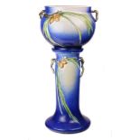 A Roseville Pinecone pattern jardiniere on pedestal, executed in blue
