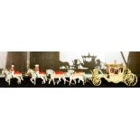 Painted cast iron model of royal carriage drawn by team of eight horses