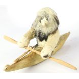 An Inuit doll and hide kayak