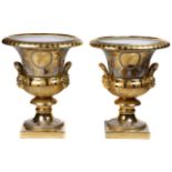 A pair of Classical style gilt decorated porcelain urns