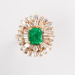 An emerald and fourteen karat gold ring