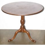 A mahogany tilt top tea table