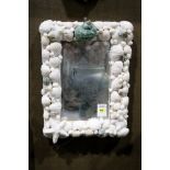 A diminutive shell encrusted mirror