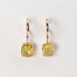 A pair of peridot and fourteen karat rose gold earrings