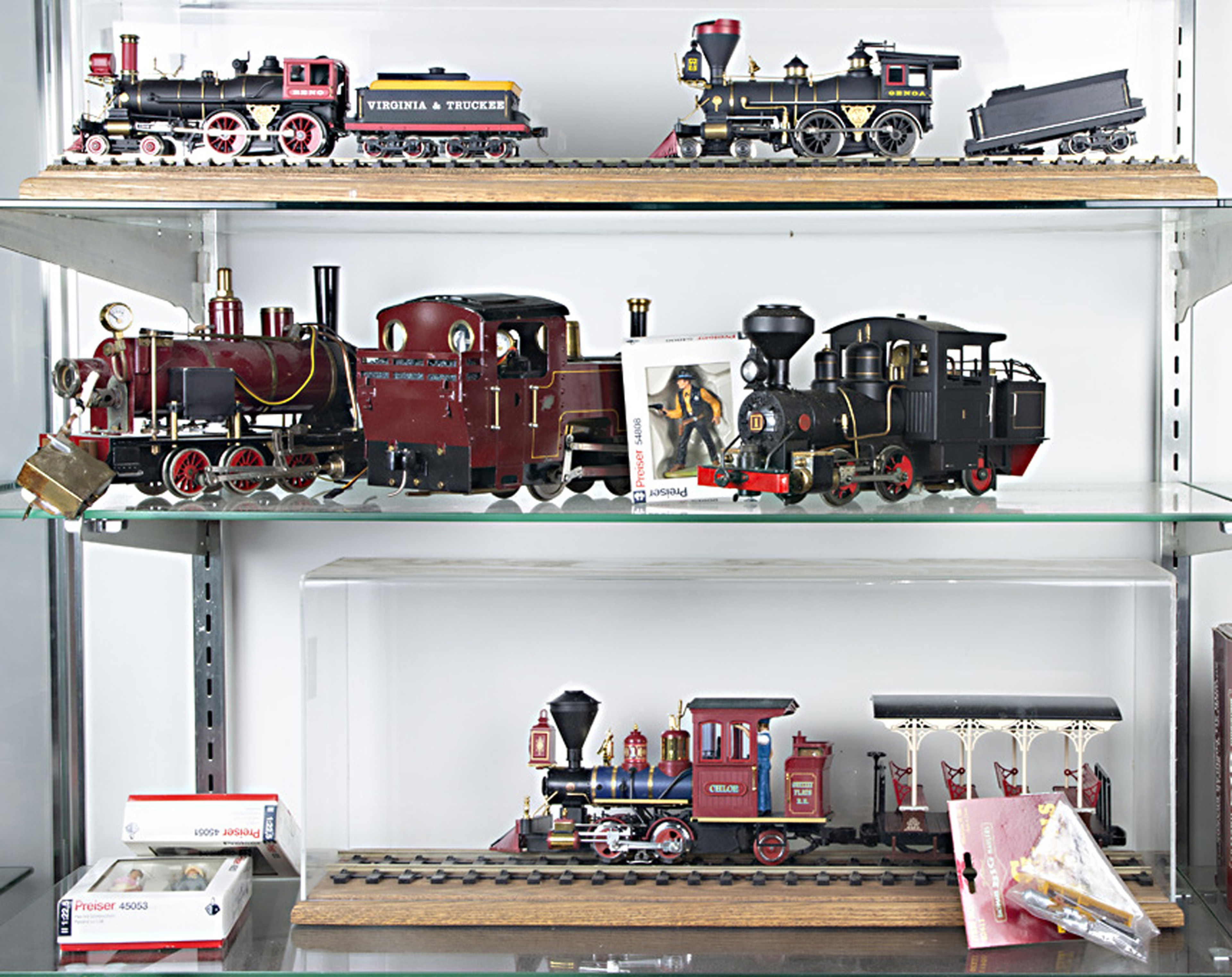 Three shelves of LGB steam engines and cars