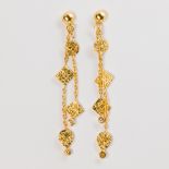 A pair of eighteen karat gold earrings