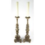 A pair of Rococo style paint decorated candle prickets