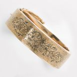 A Victorian enameled fourteen karat gold bangle bracelet