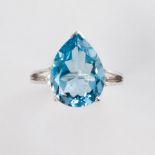 A blue topaz and fouteen karat white gold ring
