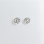 A pair of diamond and eighteen karat white gold stud earrings