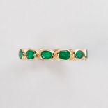 An emerald and eighteen karat gold band ring