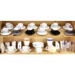 Two shelves of espresso cups and salt shakers