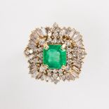 An emerald, diamond and fourteen karat gold ring