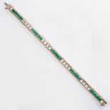 A diamond, synthetic emerald and fourteen karat gold line bracelet