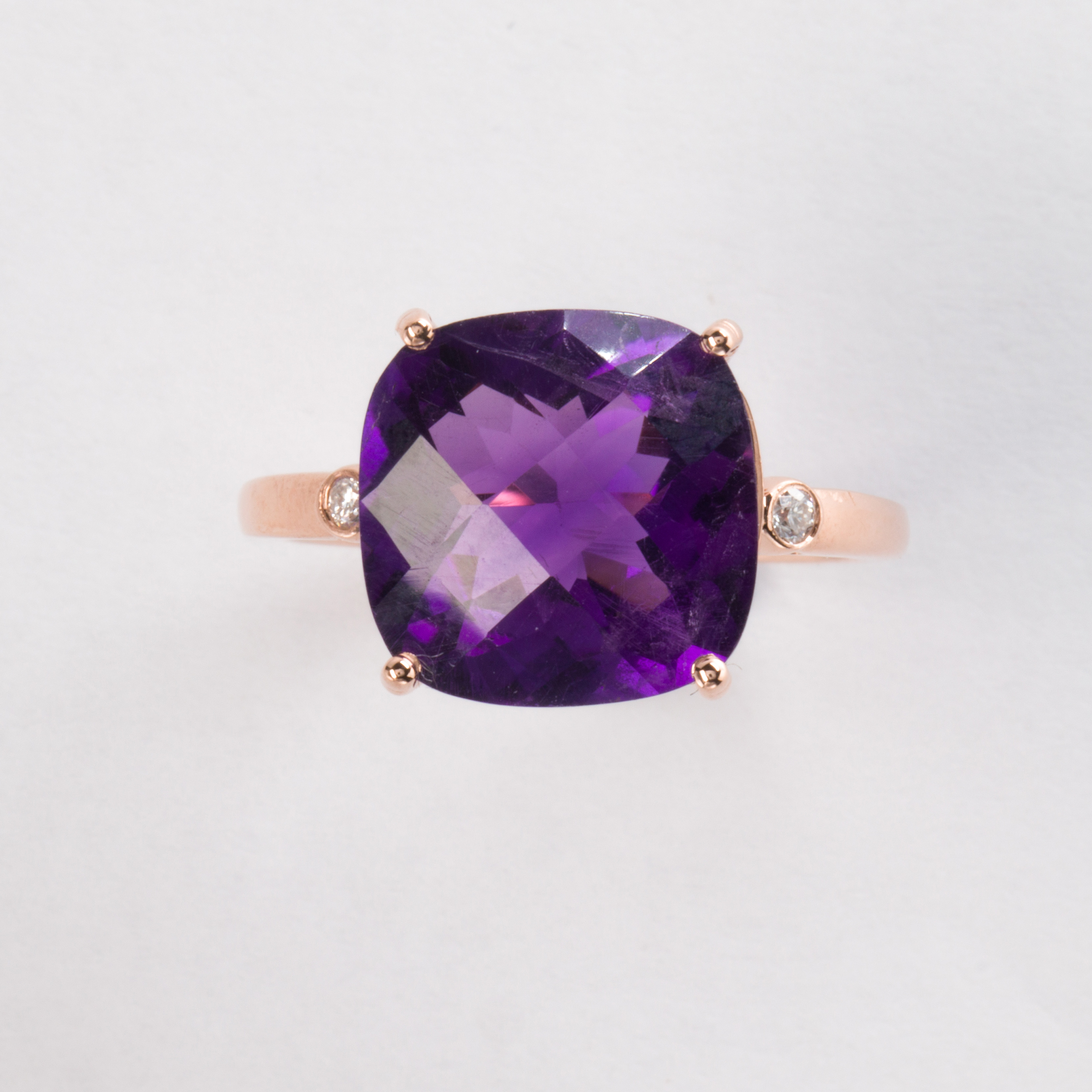 An amethyst and fourteen karat rose gold ring