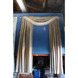 A set of drapes in checkered upholstery accented with tassels