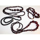 Four vintage faceted cherry amber style graduated beaded necklaces, 30in; 25in; 20; 19.5in long resp
