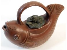 A Chinese Yixing teapot depicting carp with lily p