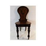 A 19thC. mahogany hall chair, 35.5in tall to back