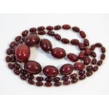 A vintage set of graduated cherry amber style beaded necklace, 37in long 70.2g, 28.3mm x 22.8mm