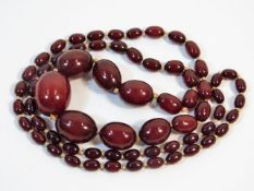 A vintage set of graduated cherry amber style beaded necklace, 37in long 70.2g, 28.3mm x 22.8mm