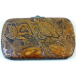 An antique ladies purse decorated with carved deco