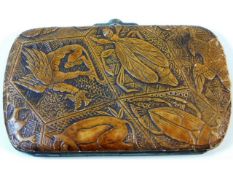 An antique ladies purse decorated with carved deco