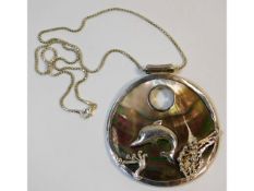 A sterling silver chain & dolphin decorated pendan