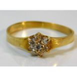 An 18ct gold ring set with seven diamonds of appro