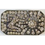 A 0.935 silver art deco brooch set with paste stones within a sun salutation design, 1.5in x 0.75in,