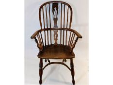 A late 18thC. elm Windsor chair with hooped crinol