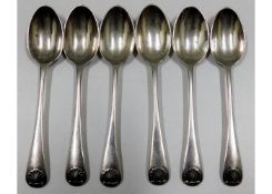 A set of six silver teaspoons with shell decor to